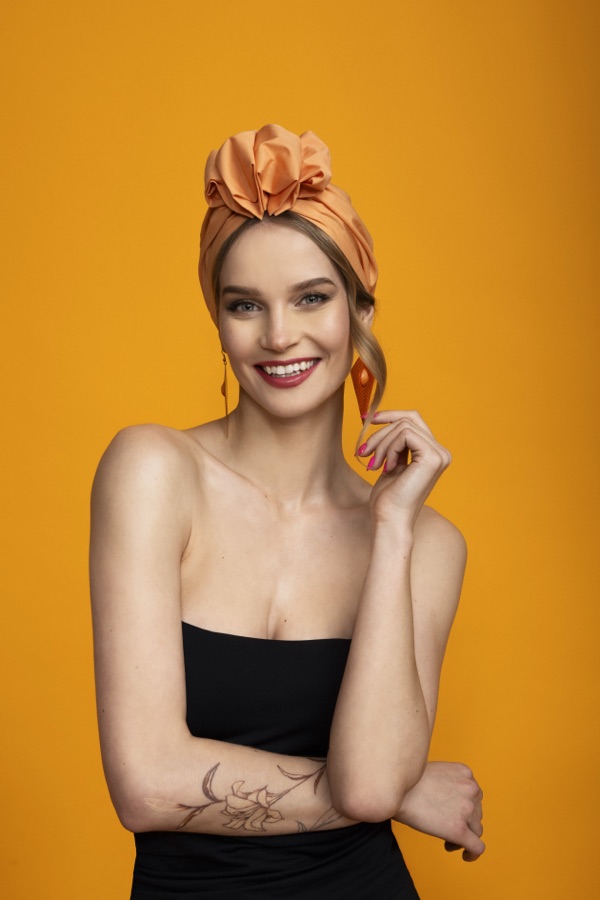 Model smiling in the Apricot turban